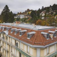 PPE complexe à Montreux avec tuiles plates et placage en zinc naturel avec plusieurs lucarne